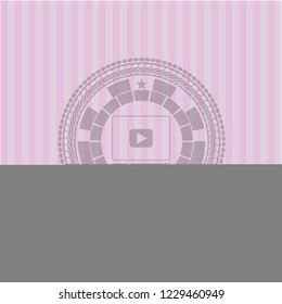 video player icon inside pink emblem