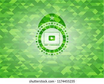 video player icon inside realistic green mosaic emblem