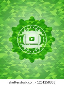 video player icon inside realistic green emblem. Mosaic background