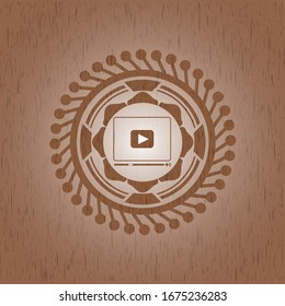 video player icon inside realistic wooden emblem