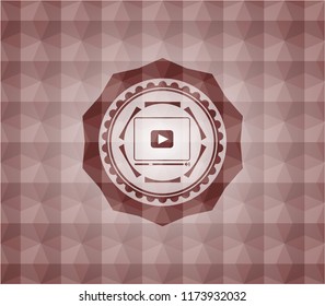video player icon inside red seamless badge with geometric background.