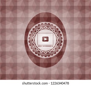 video player icon inside red seamless geometric emblem.