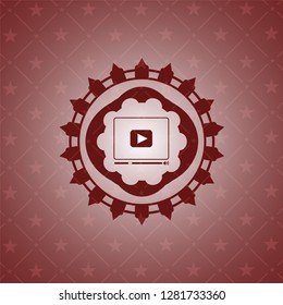 video player icon inside red emblem