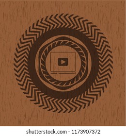 video player icon inside retro wooden emblem