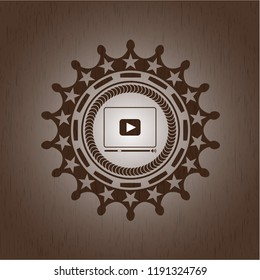 video player icon inside retro wood emblem