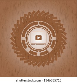 video player icon inside retro wooden emblem