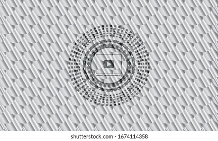 video player icon inside silver shiny emblem. Scales pattern. Vector Illustration. Detailed.