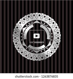video player icon inside silvery emblem