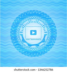 video player icon inside sky blue water badge.