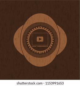 video player icon inside vintage wooden emblem