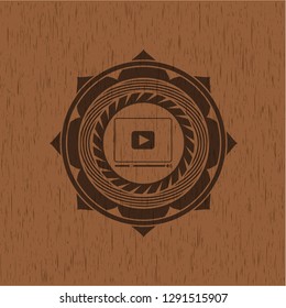 video player icon inside vintage wooden emblem