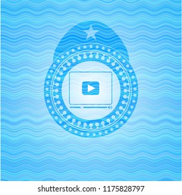 video player icon inside water badge background.