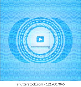 video player icon inside water wave emblem.