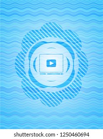 video player icon inside water badge background.