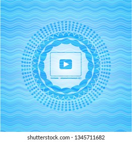 video player icon inside water representation emblem.
