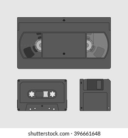Videocassette, compact cassette and floppy disk. Retro storage devices. Outdated technology concept. Black and white image