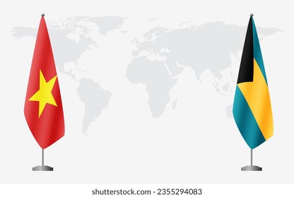 Vietnam and Bahamas flags for official meeting against background of world map.