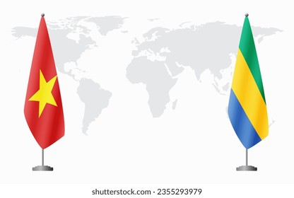 Vietnam and Gabon flags for official meeting against background of world map.