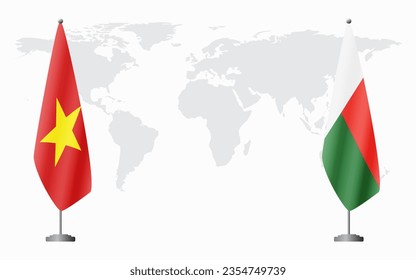 Vietnam and Madagascar flags for official meeting against background of world map.