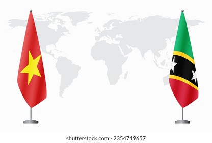 Vietnam and Saint Kitts and Nevis flags for official meeting against background of world map.