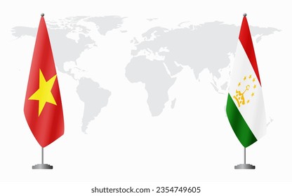 Vietnam and Tajikistan flags for official meeting against background of world map.