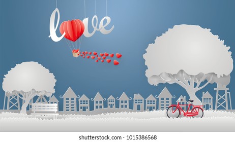 View Of The City Scape Gray Rural Town With A Heart Shaped Balloon On The Sky And Red Bicycle,gray Bench In The Park .Valentine Concept,paper Craft Style.