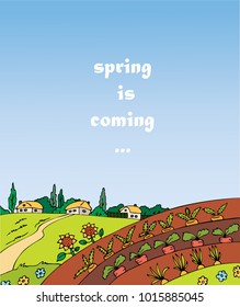 View of the field with the village. Bed with vegetables. Words spring is coming