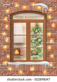 View Through A Window On The Interior Of A Christmas Living Room With The Christmas Tree And Fireplace. The Brick Facade Of The House Is Decorated With A Garland Of Light Bulbs. It's Snowing Outside.