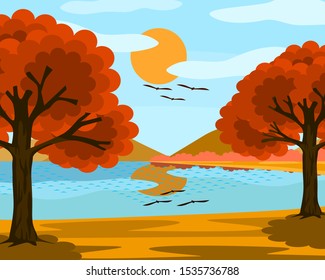 Views of the lake and the blue sky. The sun, clouds and trees with orange leaves. It is a beautiful natural image.