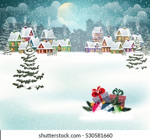 Village winter landscape with snow covered houses and  christmas tree with Christmas presents.