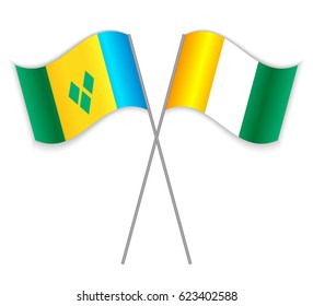 Vincentian and Ivorian crossed flags. Saint Vincent and the Grenadines combined with Ivory Coast isolated on white. Language learning, international business or travel concept.