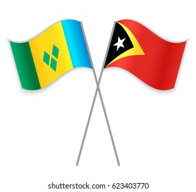 Vincentian and Timorese crossed flags. Saint Vincent and the Grenadines combined with East Timor isolated on white. Language learning, international business or travel concept.