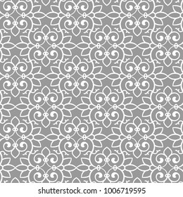 Vintage abstract floral seamless pattern. Intersecting curved elegant stylized leaves and scrolls forming abstract floral background in Arabic style. Arabesque design.