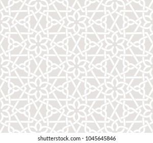 Vintage abstract floral seamless pattern. Intersecting grey curved elegant stylized leaves and scrolls on white background forming abstract floral ornament in Arabic style. Arabesque design.