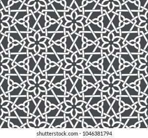 Vintage abstract floral seamless pattern. Intersecting white curved elegant stylized leaves and scrolls on grey background forming abstract floral ornament in Arabic style. Arabesque design.