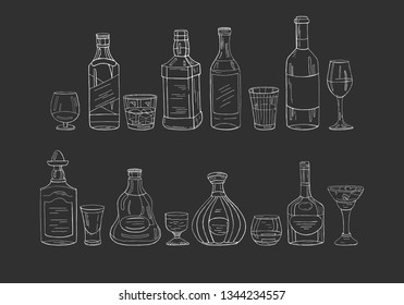 Vintage alcohol bottles and glasses on black background