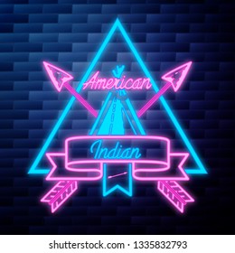 Vintage american indian emblem glowing neon sign on brick wall background