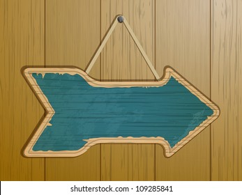 Vintage arrow sign on a wooden background