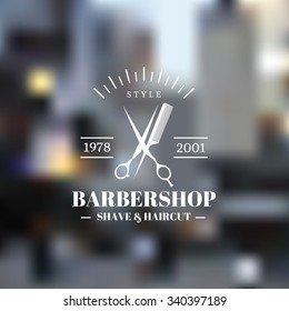 Vintage Barber shop icon emblem label or logo on blurred background