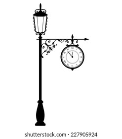 Vintage black lamppost with clock isolated on white background