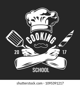 Vintage cooking classes logo with chef hat mustache crossed arms holding knife and spatula on dark background isolated vector illustration