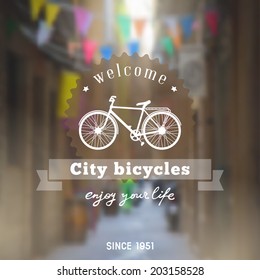 Vintage design touristic lettering with bicycle silhouette on the old european street defocused background 