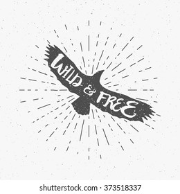 Vintage eagle with hand drawn lettering slogan. Retro silhouette monochrome animal design with inspirational typography. Motivation text. Wild and free style. Sunburst. Vector illustration.