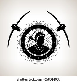 Vintage Emblem of the Mining Industry, Miner Holding a Pickax in a Gear with Two Crossed Pickaxes , Label and Badge Mine Shaft on a Light Background, Vector Illustration 