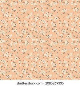Vintage floral background. Floral pattern with small white flowers on a salmon background. Seamless pattern for design and fashion prints. Ditsy style. Stock vector illustration.