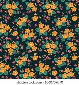 Vintage floral background. Seamless vector pattern for design and fashion prints. Flowers pattern with small yellow and pink flowers on a dark blue background. Ditsy style.