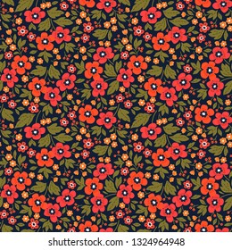 Vintage floral background. Seamless vector pattern for design and fashion prints. Flowers pattern with small red flowers on a dark blue background. Ditsy style. 
