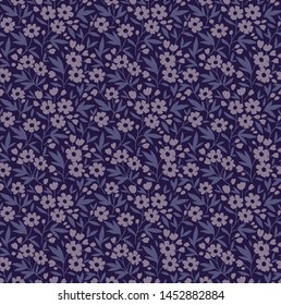 Vintage floral background. Seamless vector pattern for design and fashion prints. Flowers pattern with small lilac flowers on a dark blue background. Ditsy style.