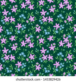 Vintage floral background. Seamless vector pattern for design and fashion prints. Flowers pattern with small lilac flowers on a dark green background. Ditsy style.