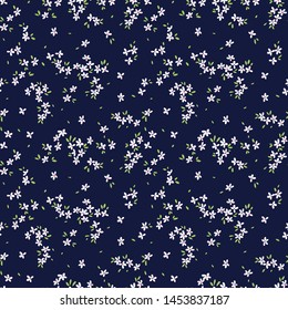 Vintage floral background. Seamless vector pattern for design and fashion prints. Flowers pattern with small white flowers on a dark blue background. Ditsy style.